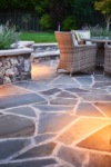 Detail of a stone patio with a table and chairs