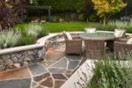 A keyhole shaped patio with a table and chairs